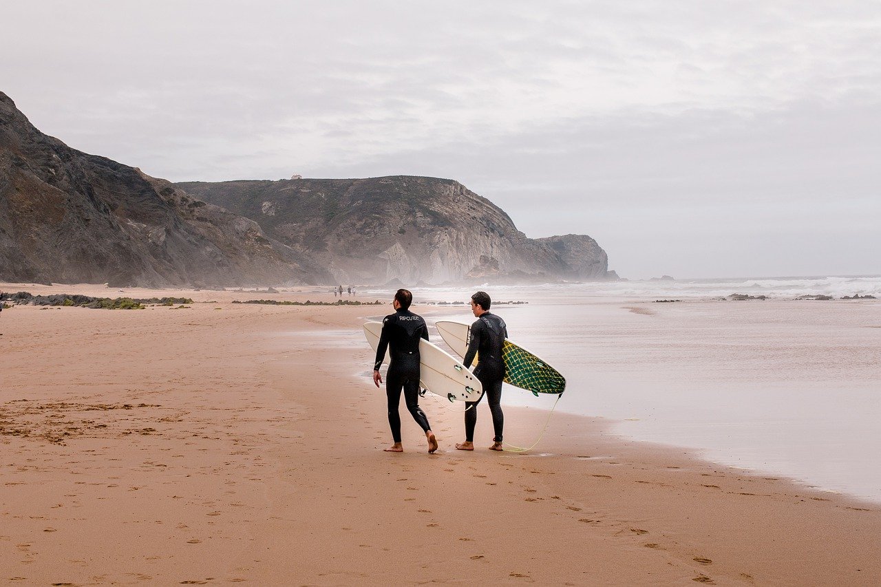 Zwei Surfer am Strand der Algarve